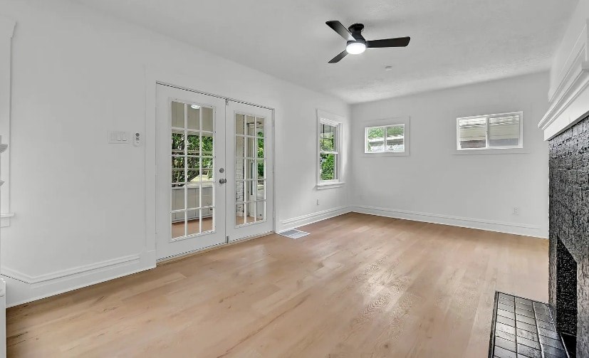 A room with a ceiling fan and a door leading outside.