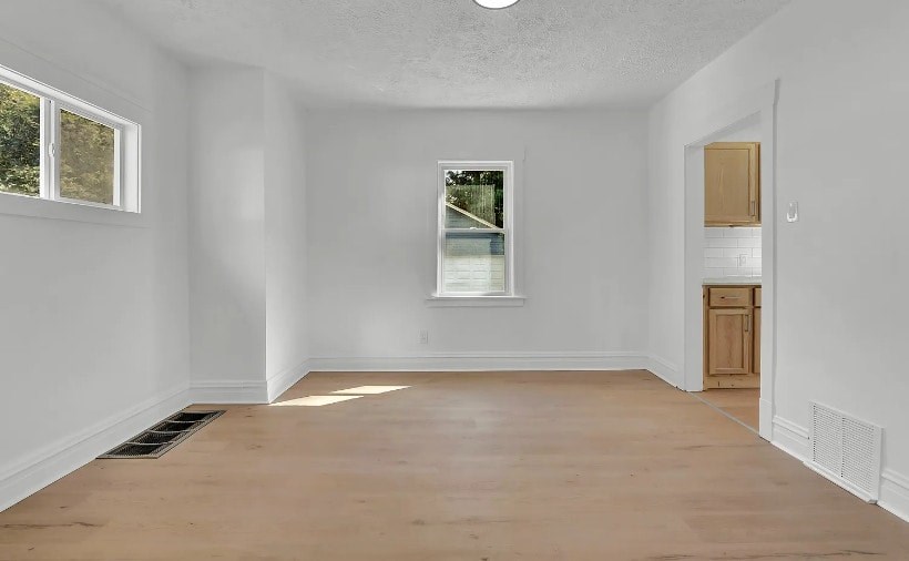 A room with a window and a door.