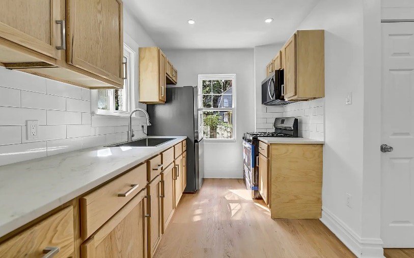 A kitchen with wooden cabinets and a white counter top.