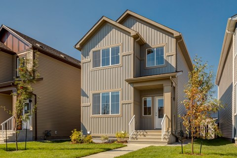 A modern house with a grey facade and a large front porch.
