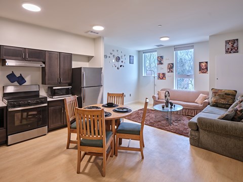 A kitchen with a table and chairs in the middle of the room.
