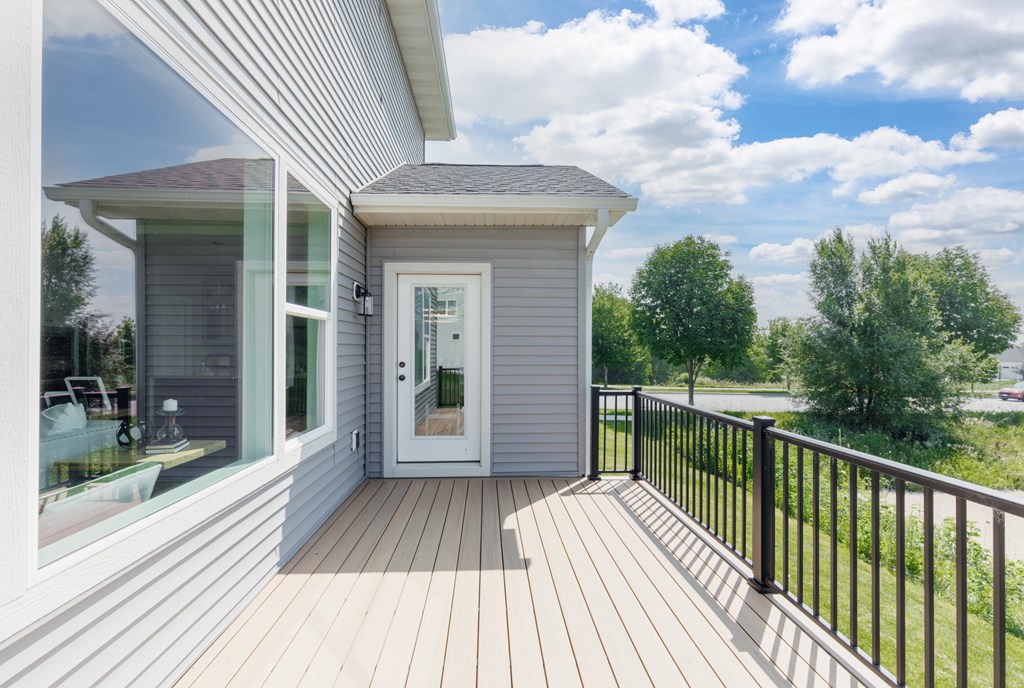 A house with a deck and a white door.