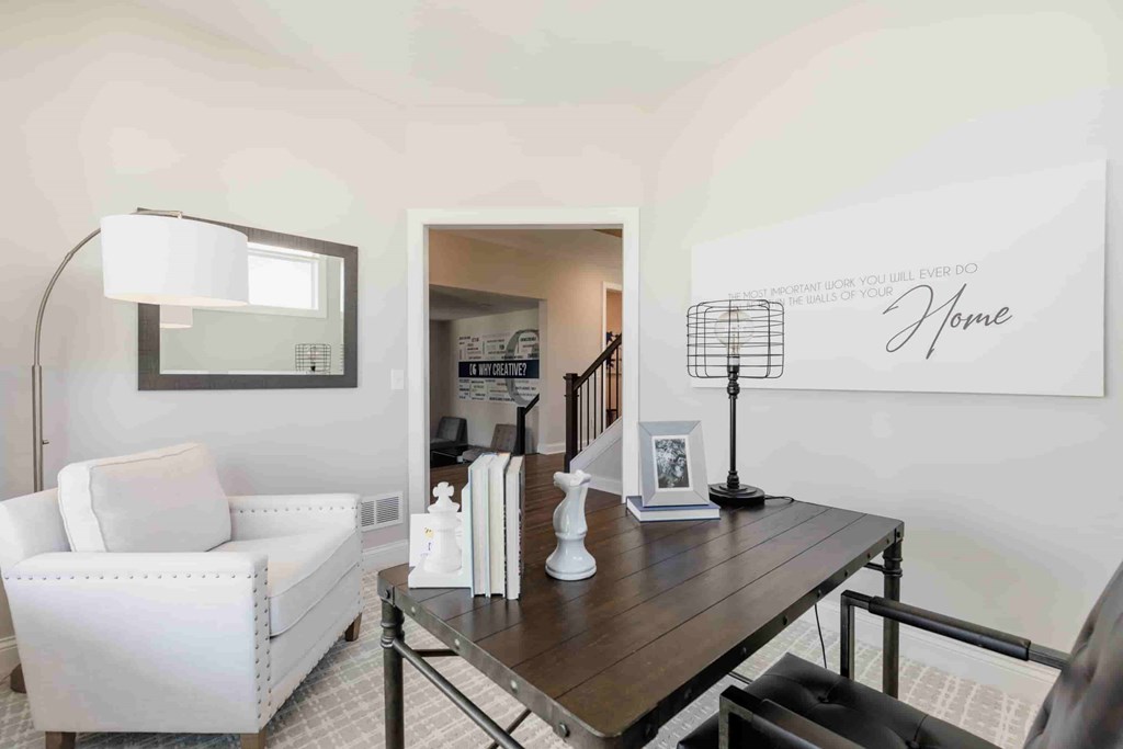 A living room with a white sofa and a wooden coffee table.