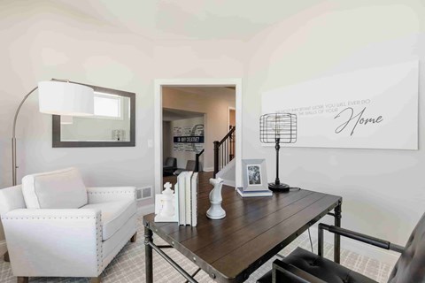 A living room with a white sofa and a wooden coffee table.