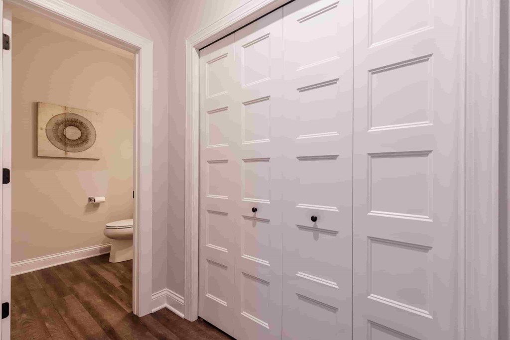 A white door with a handle is in a room.