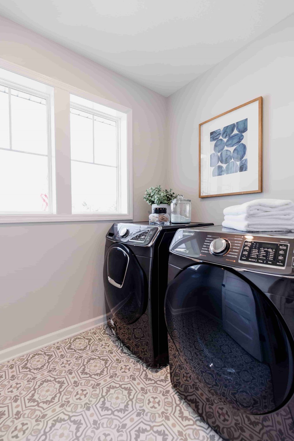 Two front loading washing machines in a laundry room.