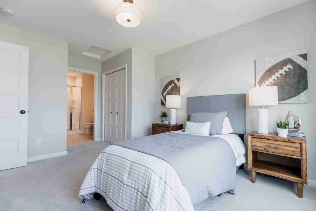 A bedroom with a bed, nightstand, and two lamps.