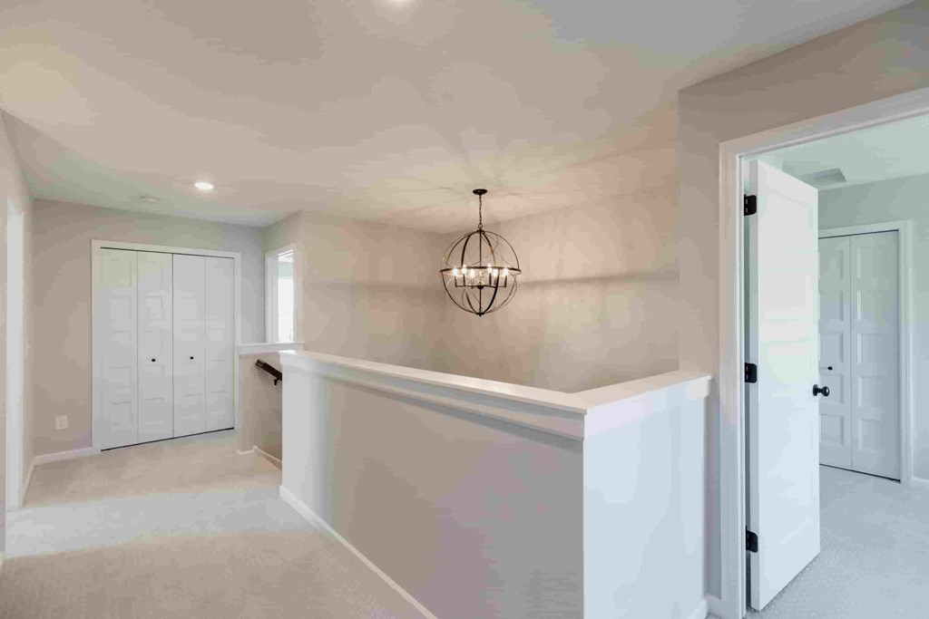 A room with a chandelier and a white door.