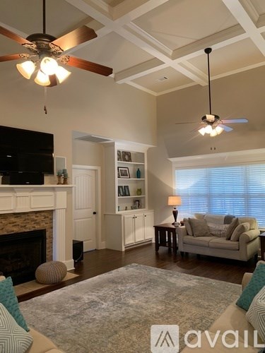 A living room with a fireplace and a television.