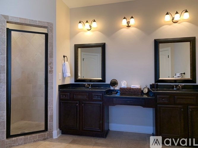 A bathroom with a double sink vanity and a large mirror above it.