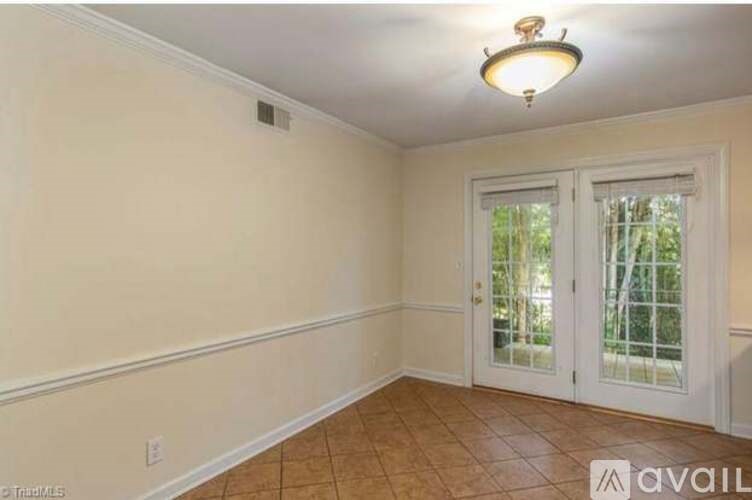 A room with a sliding glass door and a ceiling light.