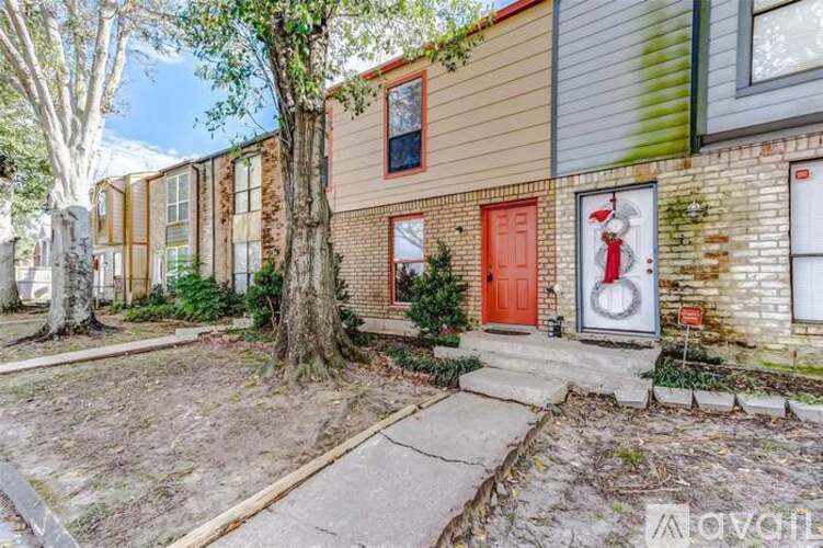 A house with a red door and a wreath on the door.