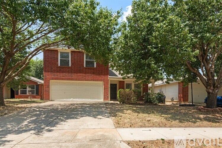 A red brick house with a white garage door in front.