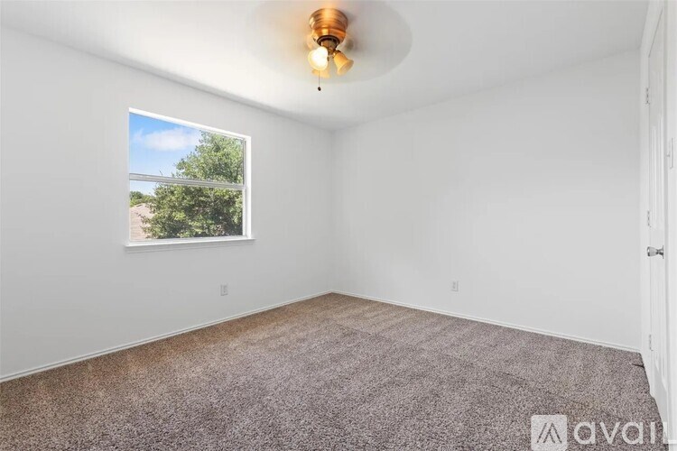 A room with a window and a ceiling light.