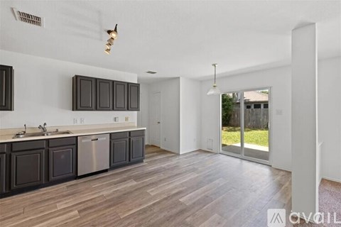A kitchen with dark wood cabinets and a white countertop.