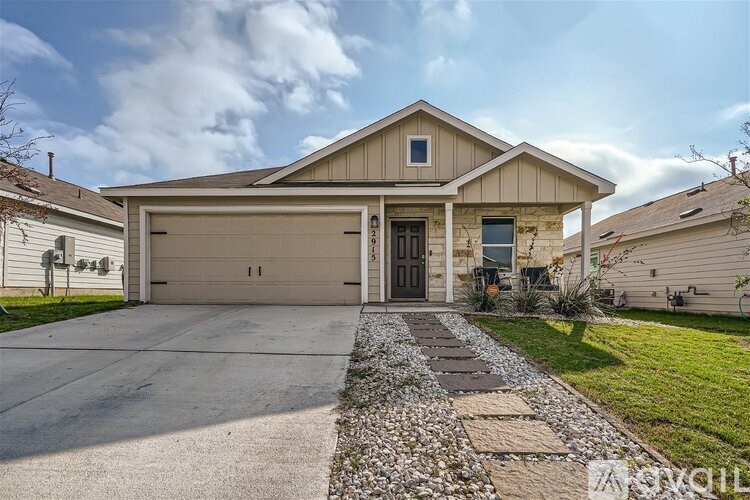 A house with a garage door and a driveway.