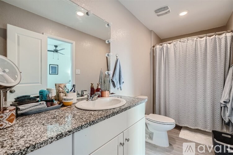 A bathroom with a sink, toilet, and shower.