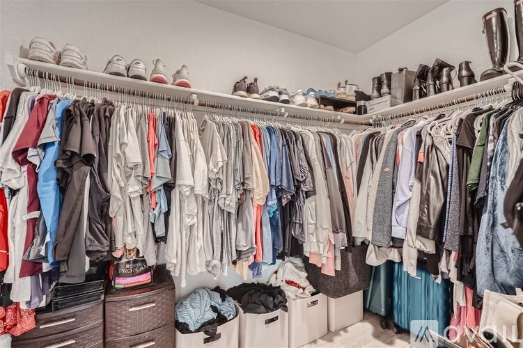 A closet full of clothes and shoes.