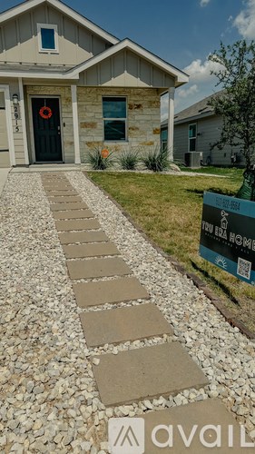 A house with a stone pathway leading to the front door.