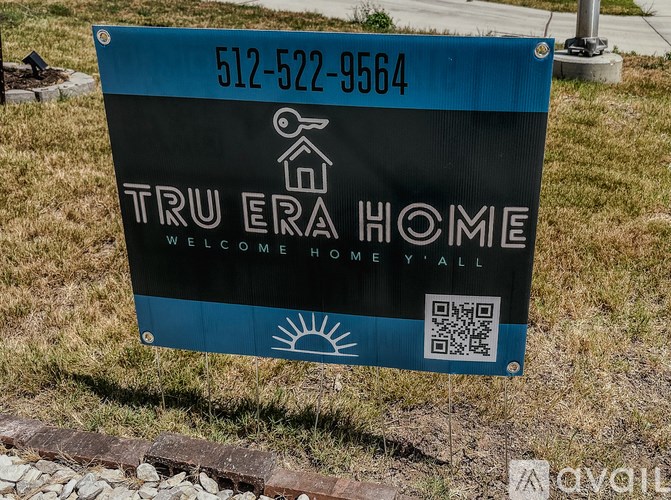 A sign for Tru Era Home with a phone number and a QR code.