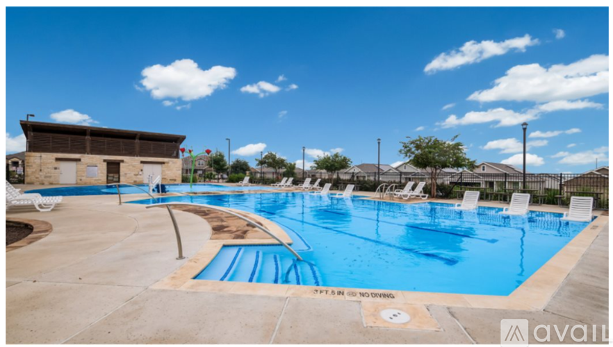 A large outdoor swimming pool with a sign that says "SPF IS ONLY RECOMMENDED".