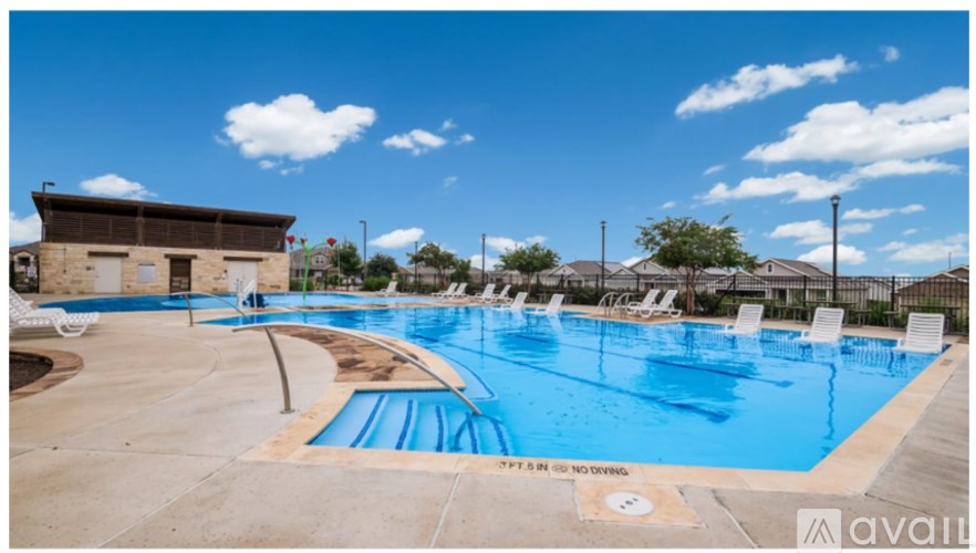 A large outdoor swimming pool with a sign that says "SPF IS ONLY RECOMMENDED".