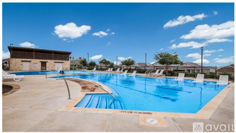 A large outdoor swimming pool with a sign that says "SPF IS ONLY RECOMMENDED".