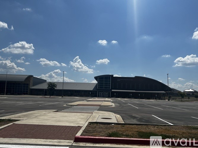 A large building with a parking lot in front of it.