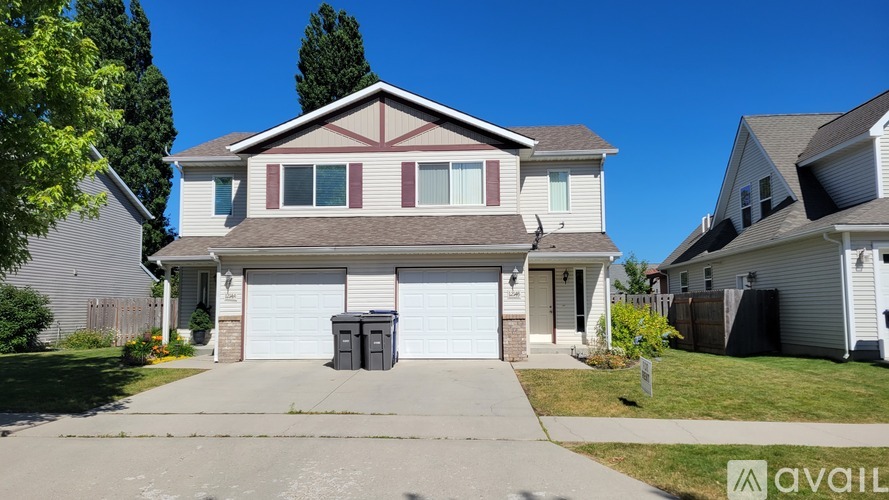A two-story house with a garage is for sale.