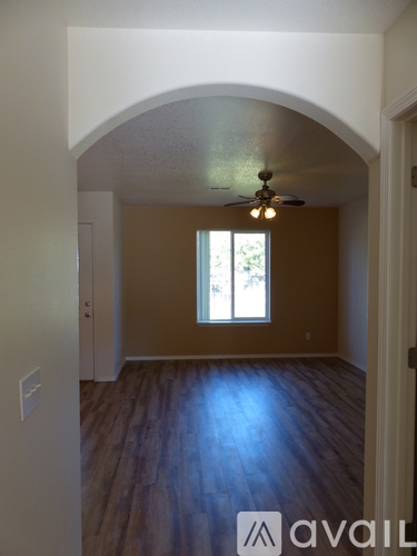 A room with a ceiling fan and a window.