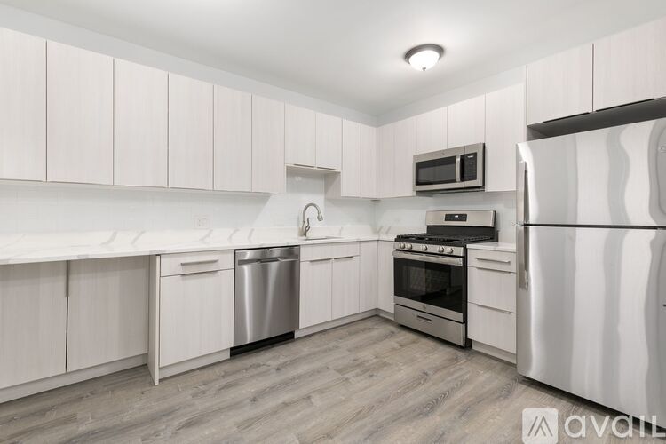 A kitchen with white cabinets and stainless steel appliances.