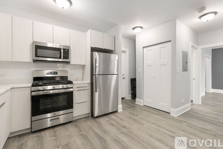 A kitchen with a stove, microwave, and refrigerator.