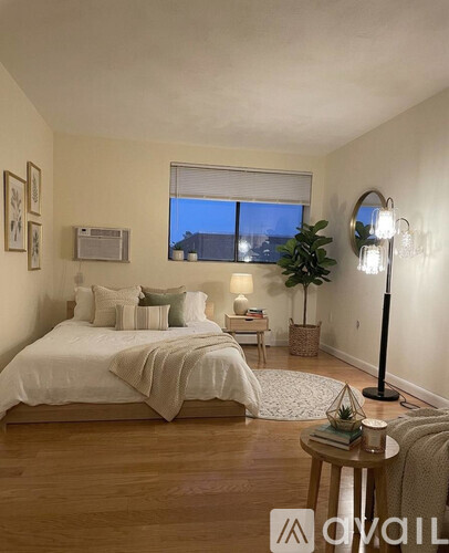 A hallway with a white door and wooden floor.