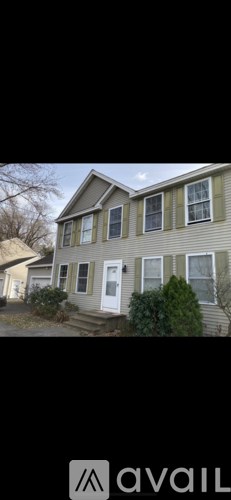 A house with a white door and windows is for sale.