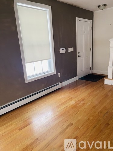 A room with a window and a door.