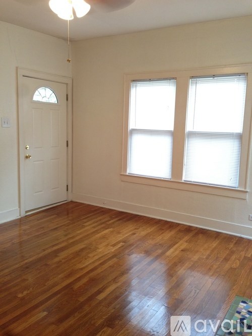 A room with wooden floors and a white door.