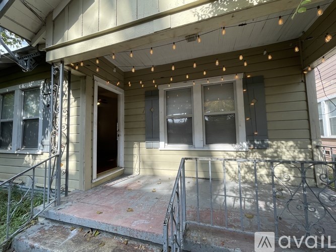 A porch with lights strung above it.