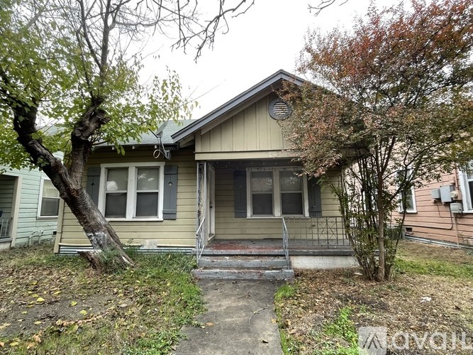 A house with a tree in front of it.