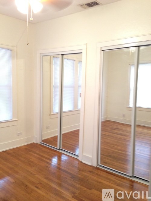 A room with a wooden floor and a sliding glass door.
