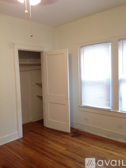 A room with a wooden floor and a white door.
