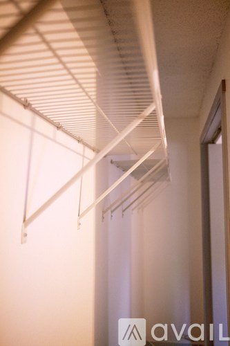 A white shutter is open and lets in light.