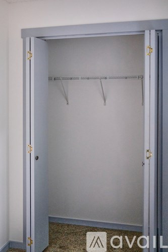 A white closet with a hanger bar and Avail logo.