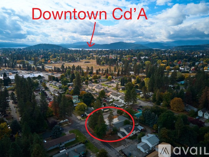 An aerial view of a downtown area with a red circle highlighting a specific location.