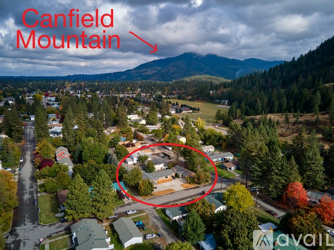 An aerial view of a town with Canfield Mountain in the background.