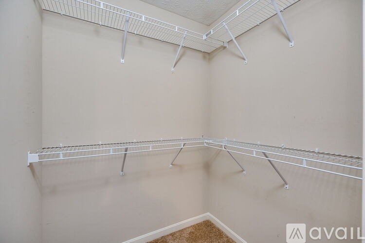 A white shelving unit is mounted on a wall.