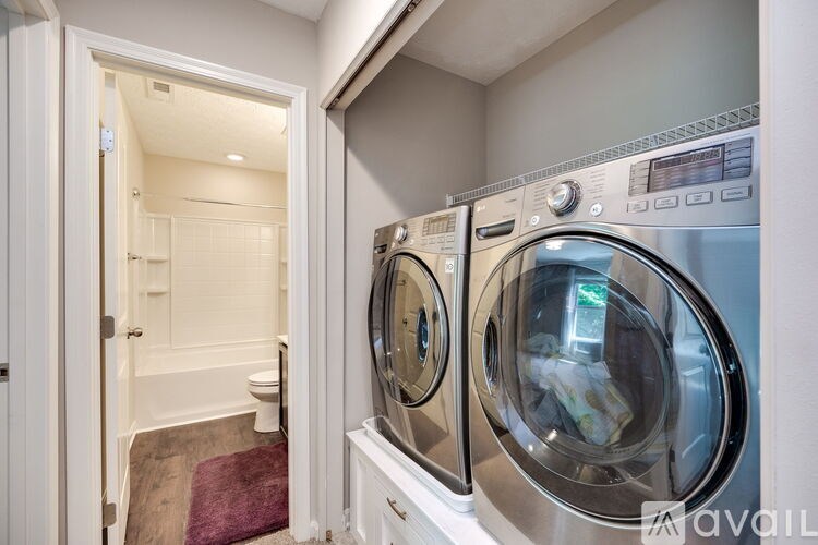 A washing machine is in a small laundry room.