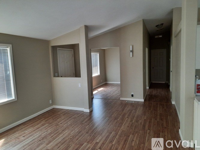 A room with wood flooring and a window.