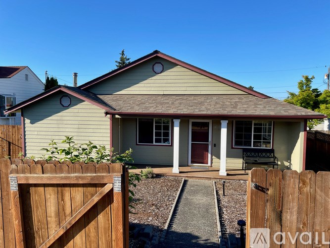 A house with a brown fence in front of it.