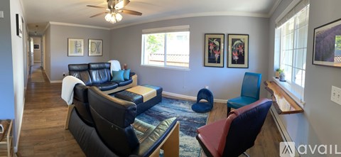 A living room with a blue chair and a red chair.