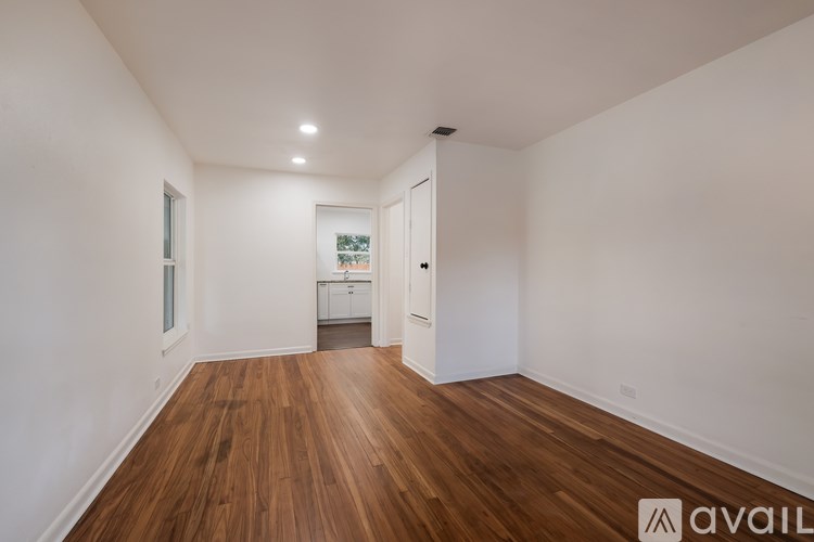 A room with wooden floors and white walls.